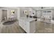 Stylish kitchen features white cabinets, quartz countertops, modern appliances, and a dining area at 1212 Belmont Circle Dr, Lancaster, SC 29720