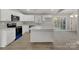 Bright kitchen featuring an open design, white cabinets, sleek countertops, and modern appliances at 1212 Belmont Circle Dr, Lancaster, SC 29720