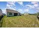 Expansive backyard with lush lawn and secure fencing, ideal for entertainment and outdoor living at 153 Pampas Pl, Statesville, NC 28625