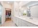 Bathroom with double sink vanity, framed mirror, and linen closet with direct access to the bedroom closet at 153 Pampas Pl, Statesville, NC 28625