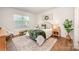 Well-lit bedroom showcasing a cozy bed with decorative pillows, hardwood floors, and matching nightstands at 153 Pampas Pl, Statesville, NC 28625