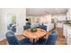 Cozy dining room with a round table and comfortable blue upholstered chairs connected to living spaces at 153 Pampas Pl, Statesville, NC 28625