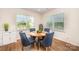 Cozy dining room with a round table and comfortable blue upholstered chairs at 153 Pampas Pl, Statesville, NC 28625