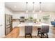 Well-lit kitchen showcasing stainless steel appliances, modern light fixtures and a large island with bar seating and countertop at 153 Pampas Pl, Statesville, NC 28625