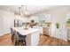 Bright kitchen with stainless steel appliances, sleek white cabinets, hardwood floors, and a functional center island at 153 Pampas Pl, Statesville, NC 28625