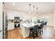 Bright, modern kitchen featuring white cabinets, stainless steel appliances, and hardwood floors at 153 Pampas Pl, Statesville, NC 28625