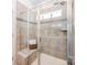Modern bathroom with a glass enclosed shower, neutral tile and convenient bench seating at 153 Pampas Pl, Statesville, NC 28625
