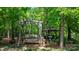 Backyard features a charming gazebo and swing, nestled among lush trees, perfect for relaxation at 1590 W 7Th St, Newton, NC 28658
