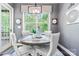 Cozy dining area featuring a round table, comfortable seating, natural light, and stylish decorations at 1590 W 7Th St, Newton, NC 28658