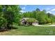 Exterior shot of a brick home in a quiet neighborhood with a green lawn and mature trees at 1590 W 7Th St, Newton, NC 28658