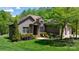 Charming single-Gathering home featuring a brick exterior, well-manicured lawn, and lush landscaping at 1590 W 7Th St, Newton, NC 28658