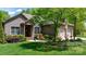 Beautiful brick home with an attached garage, a well-manicured lawn, and mature trees at 1590 W 7Th St, Newton, NC 28658