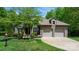 Beautiful brick home featuring an attached two-car garage, lush green lawn, and mature trees at 1590 W 7Th St, Newton, NC 28658