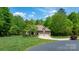 Landscaped front lawn with mature trees and a long driveway leading up to a brick home at 1590 W 7Th St, Newton, NC 28658