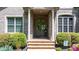 Elegant brick home entrance featuring a glass front door, brick steps, and manicured landscaping at 1590 W 7Th St, Newton, NC 28658