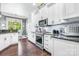 Kitchen with white cabinets, stainless steel appliances, and a view into dining room at 1590 W 7Th St, Newton, NC 28658