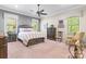 Spacious primary bedroom with a ceiling fan, windows, and ample space for furniture at 1590 W 7Th St, Newton, NC 28658