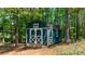 Charming green outbuilding with white trim, adding character and functional space at 1590 W 7Th St, Newton, NC 28658