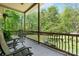 The outdoor porch features comfortable seating surrounded by lush greenery and a beautiful view at 1590 W 7Th St, Newton, NC 28658