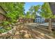 Fenced backyard with a shed, mature trees, and an elevated wood deck for entertaining and relaxing at 1716 Wickford Pl, Charlotte, NC 28203