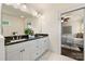 Bathroom featuring a double vanity with marble countertops, modern lighting, and doorway to the bedroom at 1716 Wickford Pl, Charlotte, NC 28203