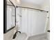Cozy bathroom features a pedestal sink and tub with a shower and classic white subway tile at 1716 Wickford Pl, Charlotte, NC 28203