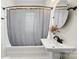 Bathroom featuring a pedestal sink and bathtub with gray shower curtain at 1716 Wickford Pl, Charlotte, NC 28203