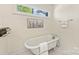 Bright bathroom featuring a soaking tub, neutral color palette, and marble tile floors at 1716 Wickford Pl, Charlotte, NC 28203