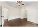 Spacious bedroom featuring wood floors, white walls, and view to an adjacent room at 1716 Wickford Pl, Charlotte, NC 28203