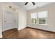 Bedroom features hardwood floors, a ceiling fan, and natural light from two windows at 1716 Wickford Pl, Charlotte, NC 28203