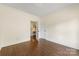 Spacious bedroom featuring hardwood floors, white trim, and a doorway at 1716 Wickford Pl, Charlotte, NC 28203