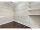 Walk-in closet offers wire shelving, hardwood floors, and ample storage space at 1716 Wickford Pl, Charlotte, NC 28203