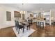 Open-concept dining area featuring hardwood floors, modern lighting, and a view into the kitchen at 1716 Wickford Pl, Charlotte, NC 28203