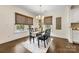 Elegant dining room with hardwood floors, chandelier, and natural light from the windows at 1716 Wickford Pl, Charlotte, NC 28203