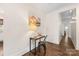 Hallway features a desk with a lamp, an art piece, and hardwood floors at 1716 Wickford Pl, Charlotte, NC 28203
