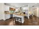 Modern kitchen boasts granite countertops, stainless steel appliances, and an island with seating at 1716 Wickford Pl, Charlotte, NC 28203