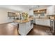 Open kitchen showcases an island with granite countertops, stainless appliances, white cabinetry, and hardwood floors at 1716 Wickford Pl, Charlotte, NC 28203