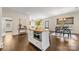 Bright open kitchen features an island with granite countertops, stainless appliances, and hardwood floors at 1716 Wickford Pl, Charlotte, NC 28203