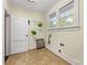 The laundry room features a window, shelving and plenty of room for sorting and folding clothes at 1716 Wickford Pl, Charlotte, NC 28203