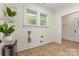 The laundry room with natural light from two windows features ample space for folding and organizing at 1716 Wickford Pl, Charlotte, NC 28203