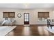 Bright living room featuring hardwood floors, multiple windows, a decorative mirror, and neutral decor at 1716 Wickford Pl, Charlotte, NC 28203