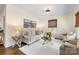 Bright living room with neutral furniture, art, hardwood floors, and a white rug at 1716 Wickford Pl, Charlotte, NC 28203