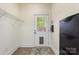 Functional mud room includes an exterior door, convenient shelving, and space for a coat rack at 1716 Wickford Pl, Charlotte, NC 28203