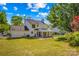 Backyard view of the house showcasing the sunroom and well-maintained lawn at 1807 Sugar Hollow Dr, Charlotte, NC 28214