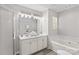 Well-lit bathroom featuring a soaking tub and double sink vanity at 1807 Sugar Hollow Dr, Charlotte, NC 28214