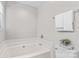 Cozy bathroom highlighting a tub with white tile and neutral walls at 1807 Sugar Hollow Dr, Charlotte, NC 28214
