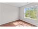 Bright, vacant bedroom with a large window overlooking the yard at 1807 Sugar Hollow Dr, Charlotte, NC 28214