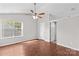 Spacious bedroom features a ceiling fan, wood-look floors, and a light-filled window at 1807 Sugar Hollow Dr, Charlotte, NC 28214