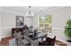 Elegant dining room with modern table, chairs, chandelier, and natural light at 1807 Sugar Hollow Dr, Charlotte, NC 28214