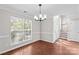 Dining room with hardwood-style floors is next to the stairs and front door at 1807 Sugar Hollow Dr, Charlotte, NC 28214
